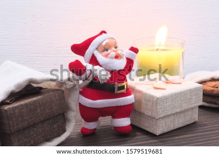 Christmas Day, Santa Claus and gift bags With candles to illuminate