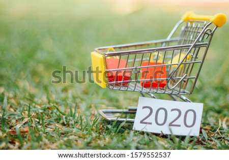 Paper shopping bags in a shopping cart on wood table, on green wall background.concept online shopping. 