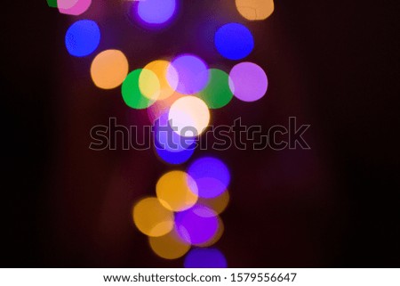 Texture of Christmas lights garlands in blur. Background of holiday lights in bokeh