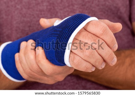 Close up picture of blue orthopedic bandage on injured wrist