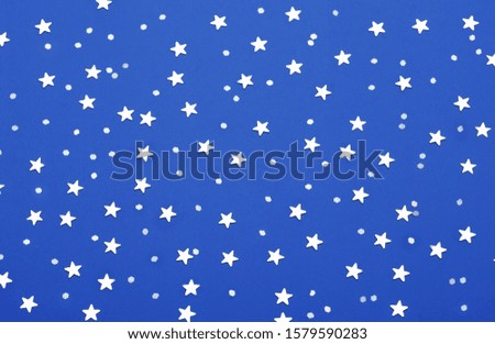 Christmas pattern made of silver stars on pink background. Classic Blue Pantone color of the year 2020 