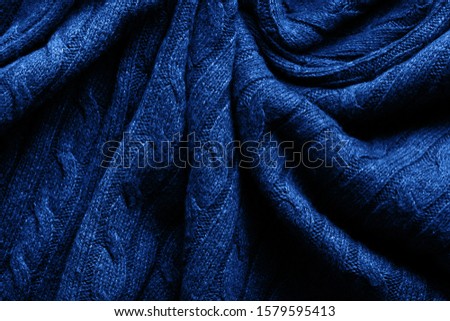 Handmade blue knitting wool texture background. Classic Blue Pantone color of the year 2020 


