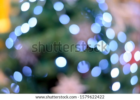 Blurry New Year and Christmas lights and Christmas toys. New Year and Christmas festive bokeh. Abstract background of garlands and Christmas toys.