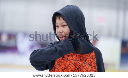 Handsome asian boy portrait at arena ice skate.