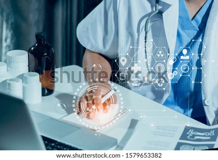 Doctor hand working on office with laptop and icon medical network connection with modern virtual screen interface. 