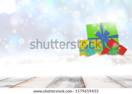 Gift box, snow pile on wooden table, Christmas and New Year and winter and the background of glittering light, abstract sky. copy space.