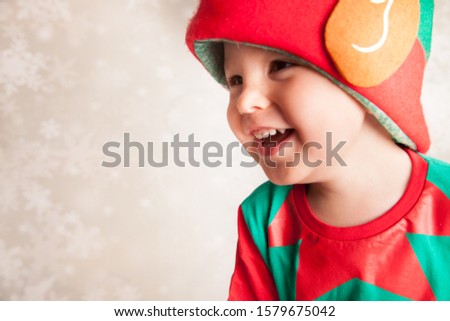 Happy Christmas, little boy with elf hat 