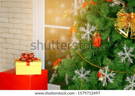 Gift boxs presents under Christmas tree in the bright living room that is beautifully decorated on Christmas day, Christmas celebration concept