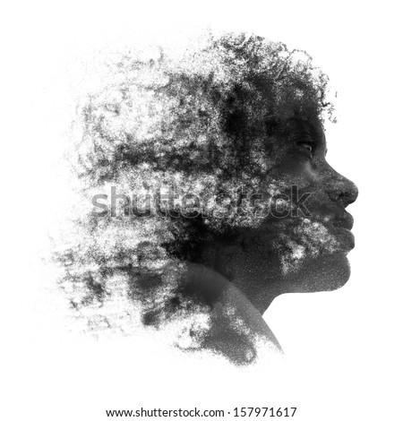 Artistic portrait of a young African woman with fine grains of sand caught in her curly frizzy hair and coating the skin of her face, black and white profile image isolated on white