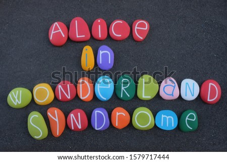 Alice in Wonderland syndrome,  neuropsychological condition that distorts perception. Creative syndrome name composed with multi colored stone letters over black sand