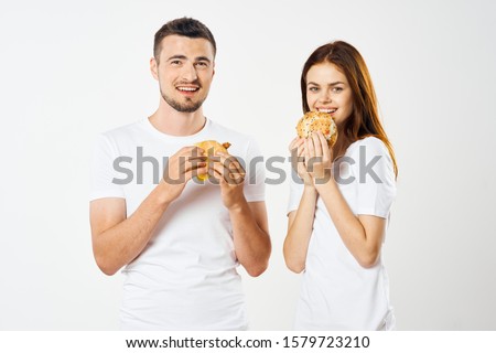 Fast food man and woman T-shirt with hamburger in hands