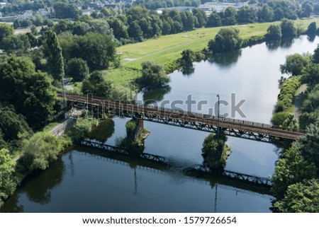Aerial view railway bridge passes over a river