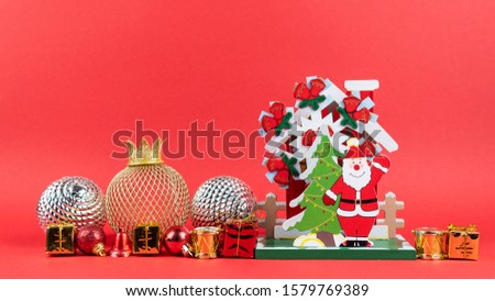 Stop motion animation of New Years balls, gift and bis wooden Santa Claus figurine. Concept of Christmas and holiday. Copy space