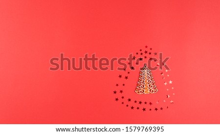 Concept of Christmas and New Year holiday and sale. Flat lay of wooden Christmas tree, confetti stars, cone and balls. Top view stop motion animation