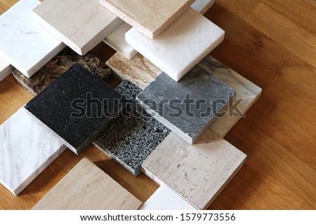 color samples of marble  on oak wood table, stone surface Royalty-Free Stock Photo #1579773556
