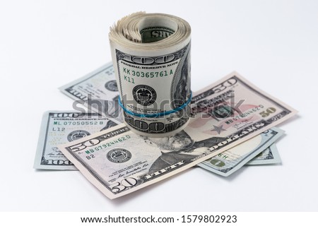 Roll of american dollars on a white background. Financial concept.
