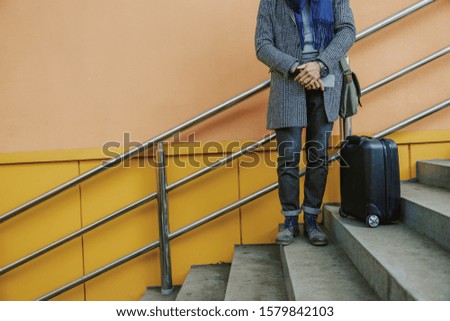 Elegant gentleman with mobile phone standing on steps stock photo. Website banner