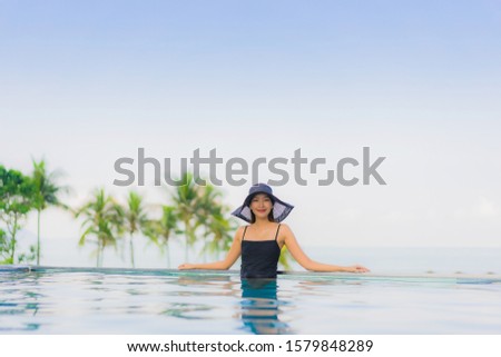 Portrait beautiful young asian women happy smile relax outdoor swimming pool in hotel resort in vacation