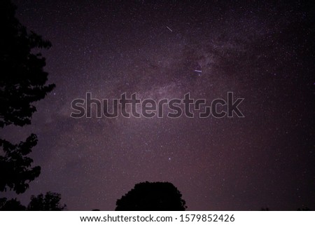 Star sky night concept, milky way and star on night sky over Mor hin khao, famous landmarks in Chaiyaphum province, Thailand, dark black stone and tree shadow