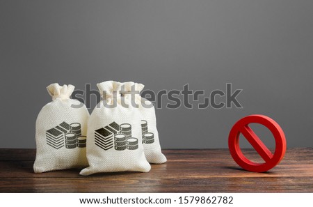 Money bags and red prohibition sign no. Restrictions on the export of capital, Economic pressure and sanctions. Lack of investment and inflow of finance. Regulatory laws in the financial sector. Royalty-Free Stock Photo #1579862782