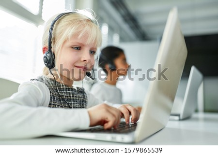 Girl as an employee with headset in the hotline in the business call center