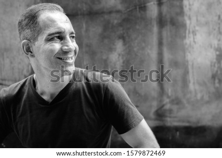 Portrait of mature Persian man outdoors in black and white