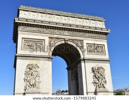 Arc de Triomphe on a sunny day. View from Champs Elysees. Paris, France. 