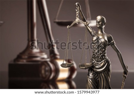 Law statue symbols composition on dark table.