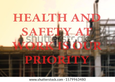Bokeh of work contraction background with word HEALTH AND SAFETY AT WORK IS OUR PRIORITY                     