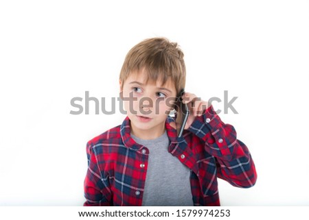
boy talking on the phone in a stylish shirt. isolated on a white background. Interesting conversation Royalty-Free Stock Photo #1579974253