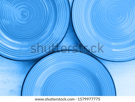 Classical blue ceramic dishes top view background. color of 2020