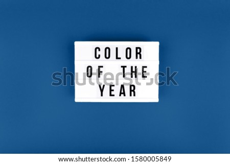 Retro lightbox with Color of the year wording on the trendy solid blue backdrop, place for text