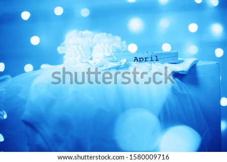Costume for a newborn girl. Booties, bodik, beautiful bokeh lights. April month and blue toned