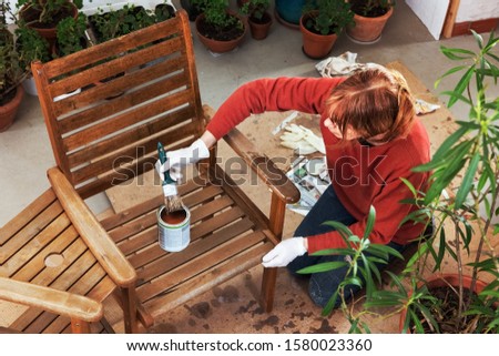 Maintaining an Outdoor Bench, Sanding and Painting Royalty-Free Stock Photo #1580023360