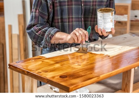 Painting Recycled Planks with Wood Oil Royalty-Free Stock Photo #1580023363