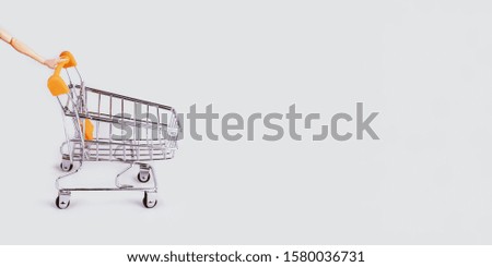 Banner with shopping cart and hand. Grocery shopping and sale concept. Black friday, online shopping and store concept. Sale discount. Background with copyspace. Creative design. Stock photography.