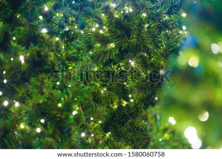 Christmas tree with ornaments for Christmas season decorative hanging in a tree, Festive Xmas border of green branch of pine close up