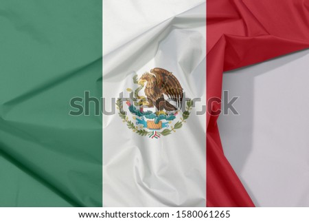 Mexico fabric flag crepe and crease with white space, a vertical tricolor of green white and red with the nation Coat of Arms centered on white.