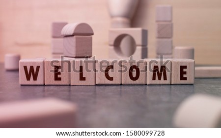 Word "Welcome" written with wooden blocks