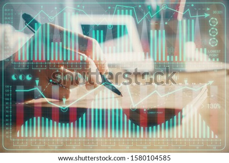 Financial charts displayed on woman's hand taking notes background. Concept of research. Double exposure