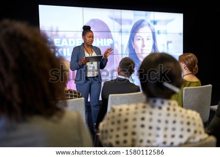 Female-driven presentation by pretty millennial African American Royalty-Free Stock Photo #1580112586