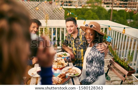 Group of diverse friends taking selfies pictures having dinner a