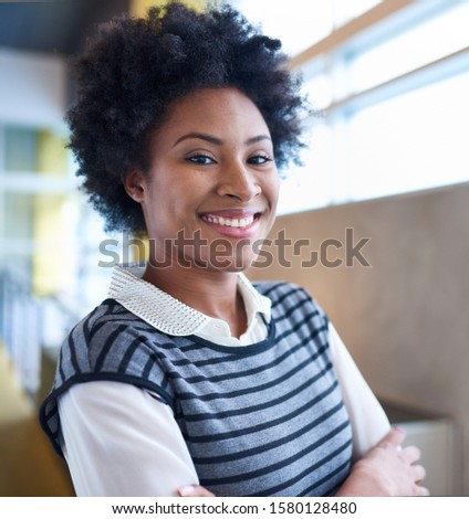 Confident young african american business woman with arms crossed