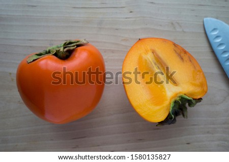 Fresh persimmon on a wooden table