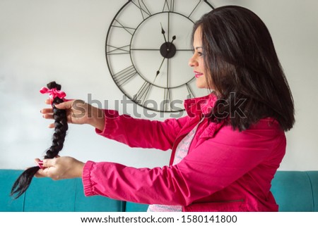 Young woman offering braid hair in solidarity for patients with 