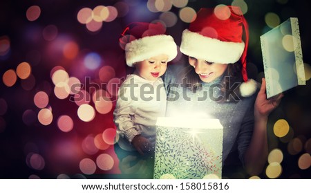 Christmas magic gift box and a woman happy family mother and Child baby