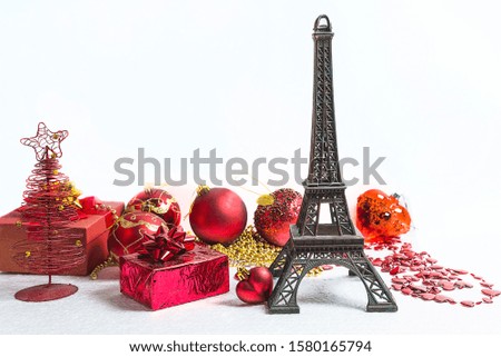 Christmas holiday in Paris concept. The Eiffel tower and red christmas decorations on the white background
