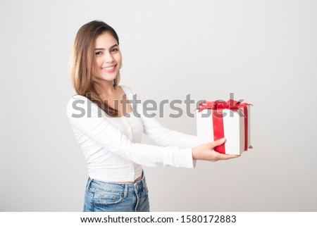 Beautiful woman is holding gift box on white background 