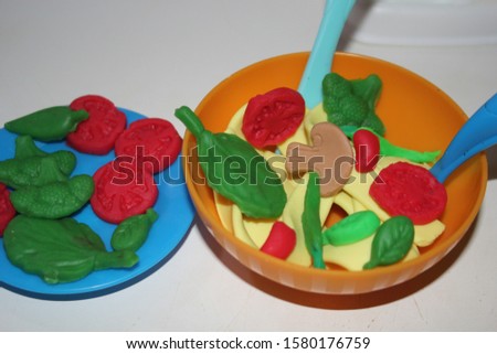play doh pasta and vegetables on white background  image