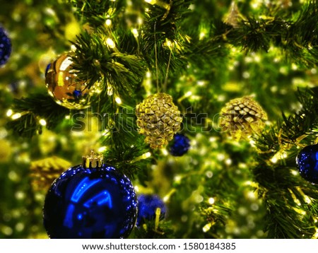 the gold and green ornament decoration on pine Christmas tree for the new year holiday festival 